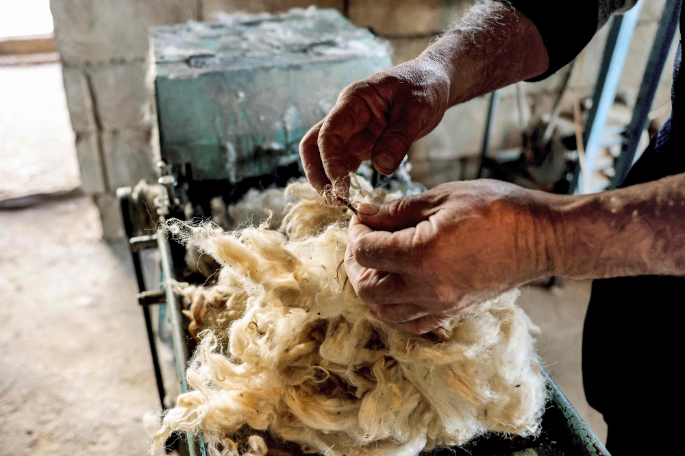 Hatmaker Youssef Akiki cleans and processes sheeps wool before shaping it into a traditional 