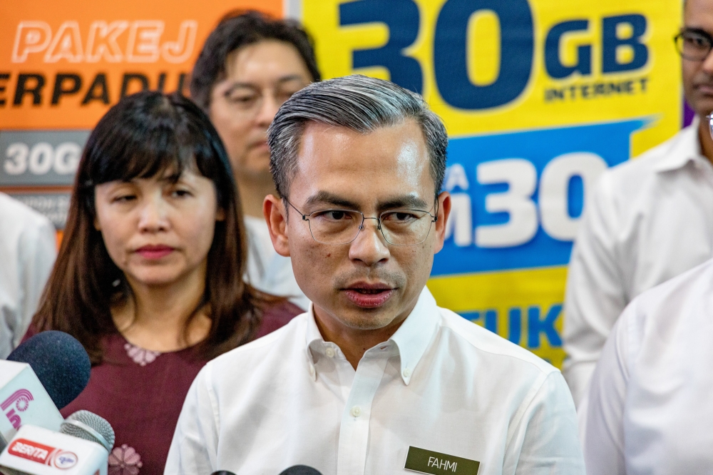 Communications and Digital Minister Fahmi Fadzil speaks at the Mobile Internet Unity Package pre-launch ceremony at Perumahan Awam Desa Rejang, Setapak February 28, 2023. — Picture by Firdaus Latif 