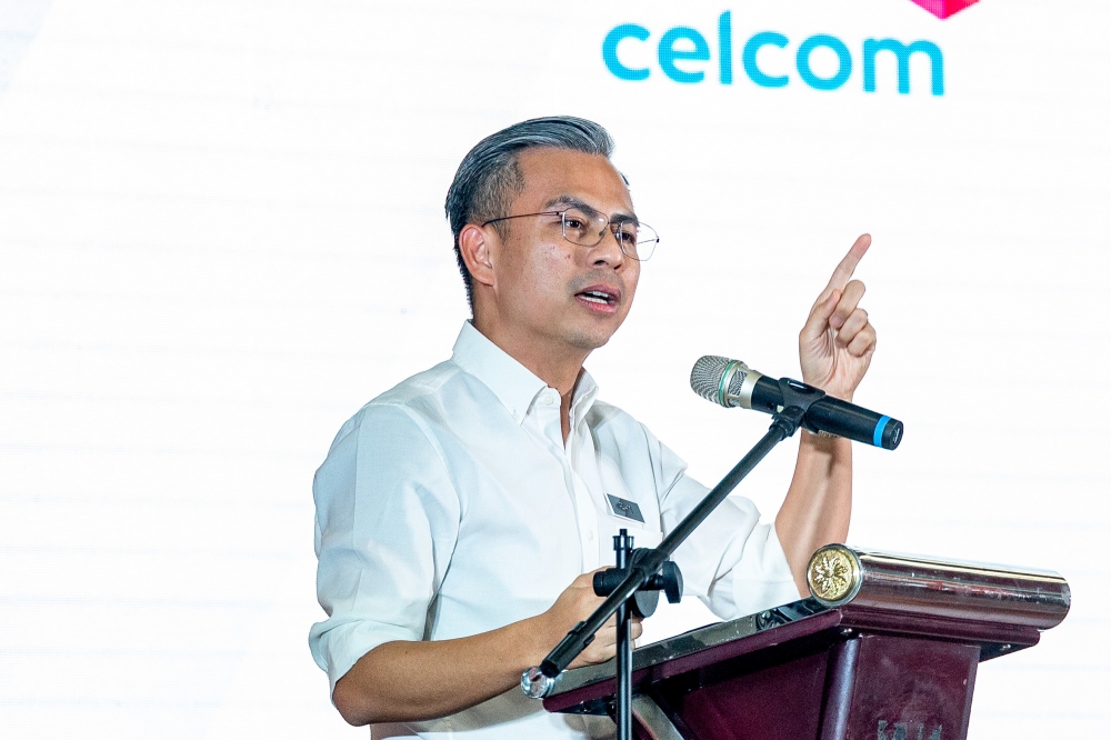Communications and Digital Minister Fahmi Fadzil speaks at the Mobile Internet Unity Package pre-launch ceremony at Perumahan Awam Desa Rejang, Setapak February 28, 2023. — Picture by Firdaus Latif