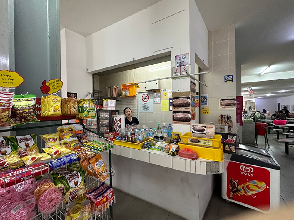 Carol runs the kiosk at Gerai Atria SS22 Damansara Jaya with her autistic son to help him live and work independently.