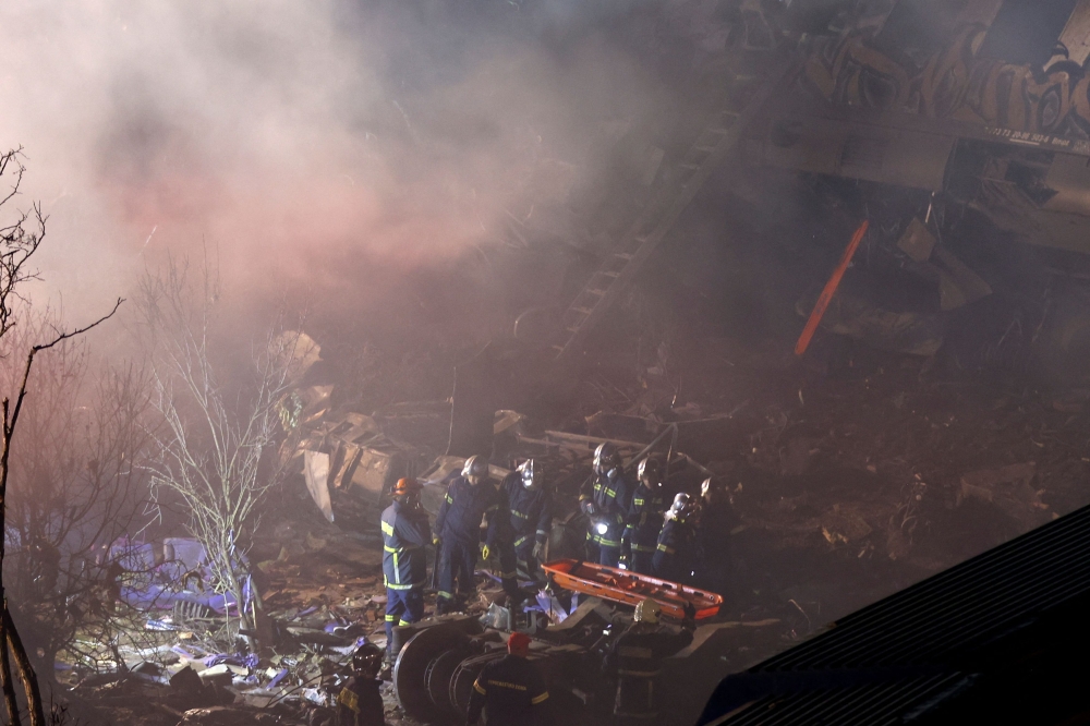 Firefighters at the site of a crash. — Reuters pic
