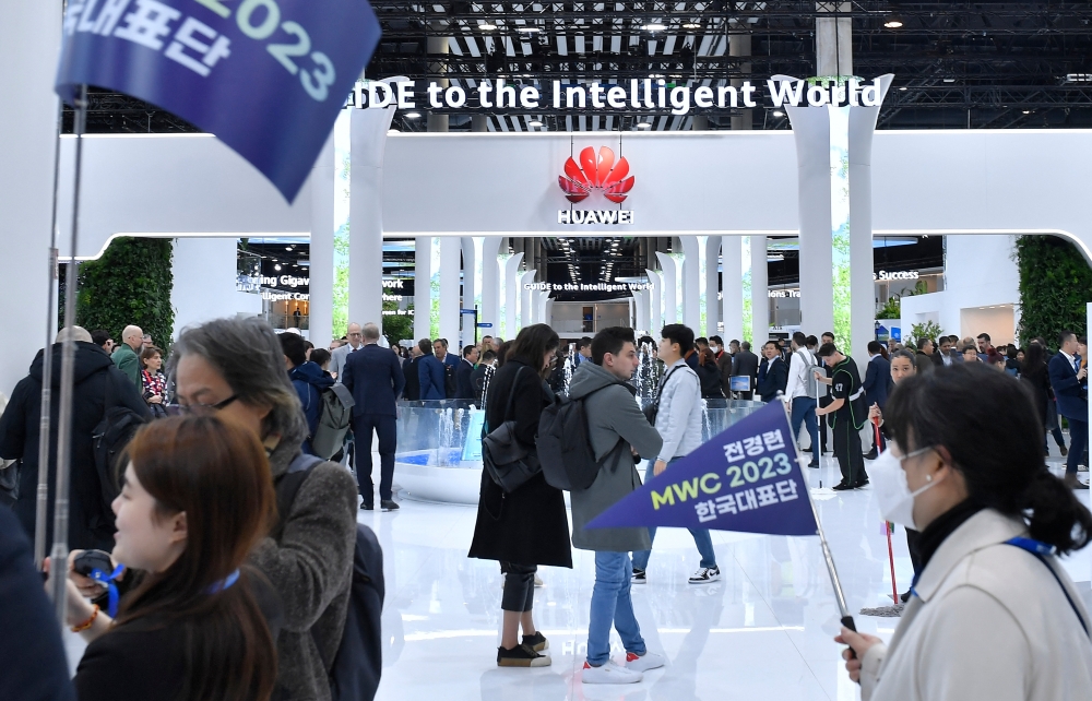 Visitors walk next to Chinese manufacturer Huawei stand at the Mobile World Congress (MWC), the telecom industry's biggest annual gathering, in Barcelona on February 28, 2023. — AFP pic