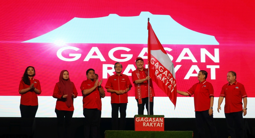 Gabungan Rakyat Sabah chairman Datuk Seri Hajiji Noor (3rd right) waves the coalition’s flag during an event in Kota Kinabalu March 2, 2023. — Picture by Julia Chan