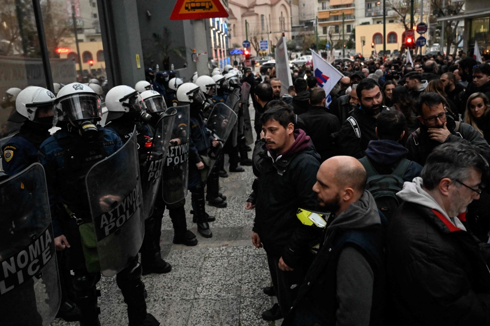 Riot police forming a security cordon in front of the Hellenic Train headquarters in Athens March 2, 2023. — AFP pic