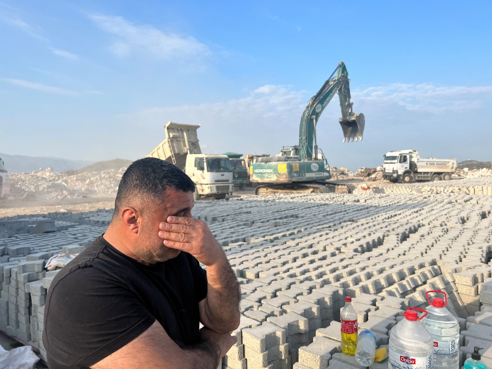 Altan Arslan, owner of a brick and cement block factory where post-earthquake rubble is dumped, reacts as he talks to Reuters on the outskirts of Antakya in Hatay province, Turkey February 25, 2023. — Reuters pic