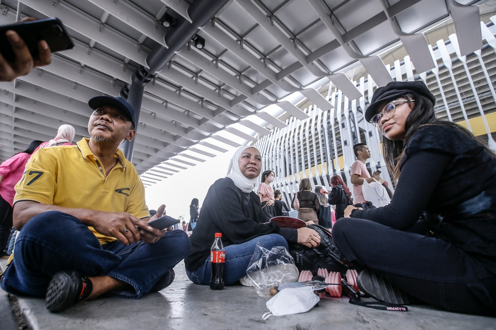 Fans of popular girls group Linda and her husband accompany their daughter speak to reporter during the Born Pink world Tour Kuala Lumpur concert at Bukit Jalil Stadium March 4, 2023. — Picture by Hari Anggara