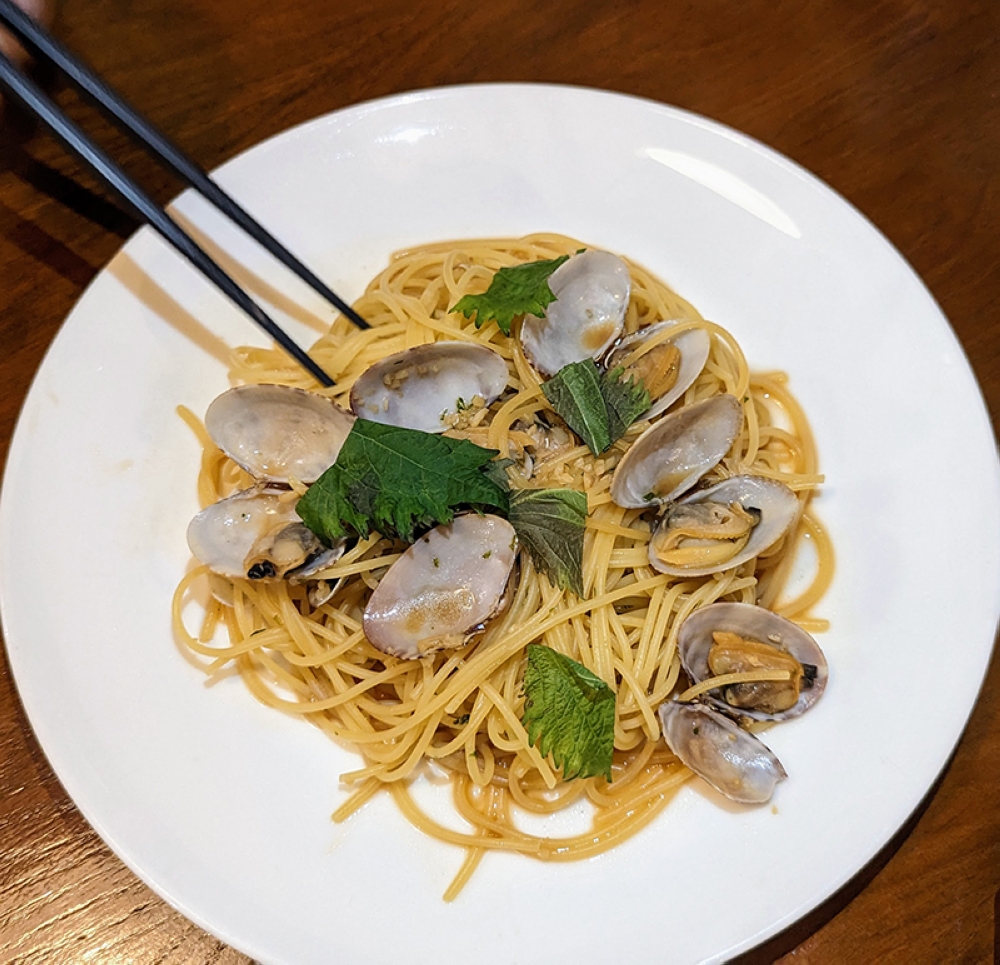 Al dente pasta is paired with Japanese clams in garlic butter and soy sauce.