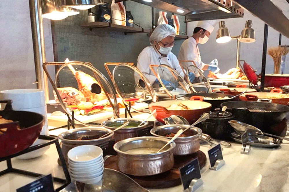 Busy cooks at a hotel’s buffet line.
