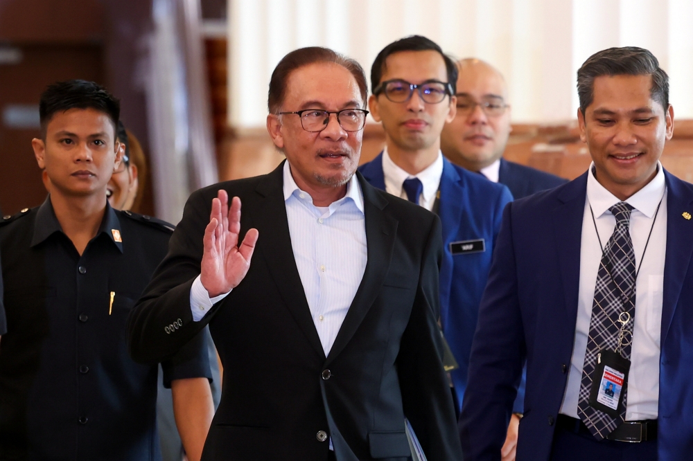 Prime Minister Datuk Seri Anwar Ibrahim (second left) arrives at the Parliament in Kuala Lumpur March 7, 2023. — Bernama pic