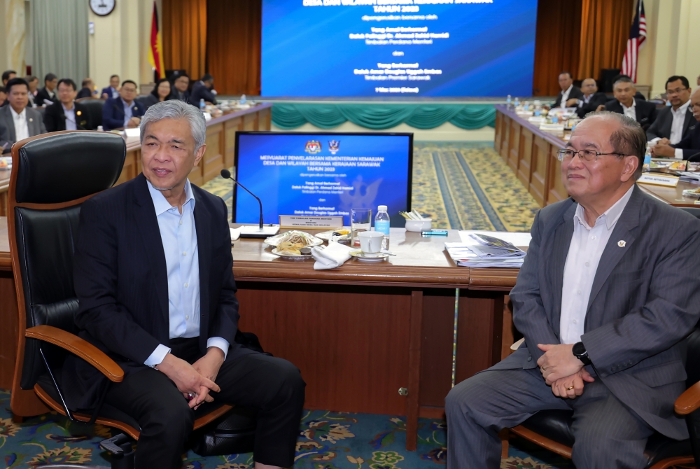 Deputy Prime Minister Datuk Seri Ahmad Zahid Hamid (left) and Sarawak Deputy Premier  Datuk Amar Douglas Unggah Embas (right) during a meeting in Kuching March 7, 2023. — Bernama pic