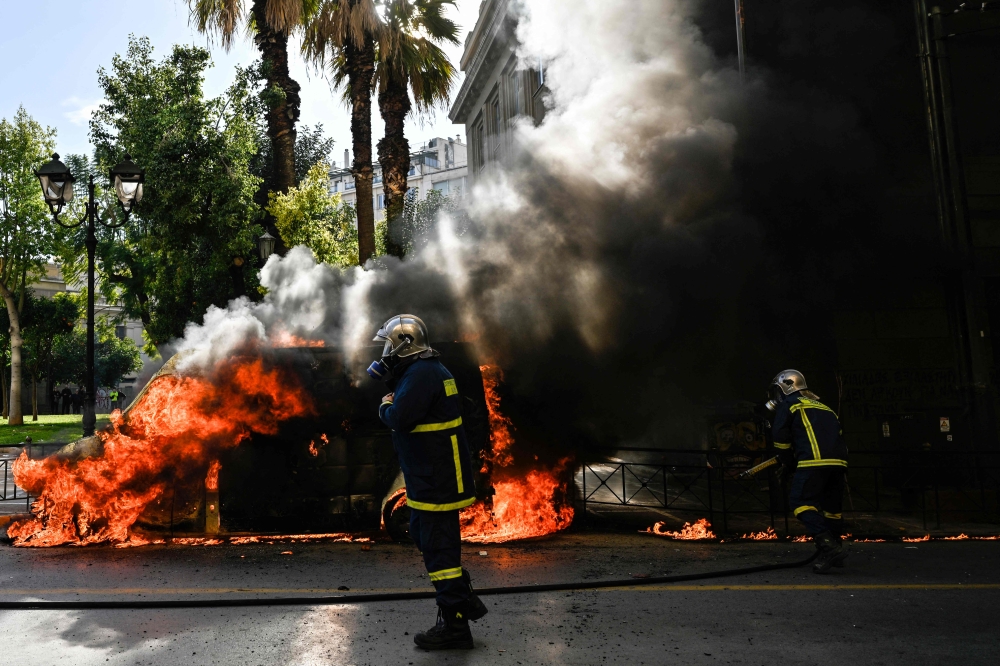 Demonstrators also torched a van. — AFP pic