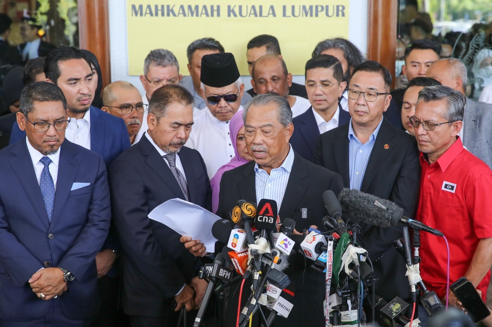 Former prime minister Tan Sri Muhyiddin Yassin speaks during a press conference outside the Kuala Lumpur High Court complex March 10, 2023. — Picture by Yusof Mat Isa