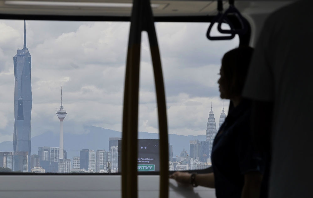 A media personnel is seen on a test ride on the MRT Putrajaya Line from the Putrajaya Sentral station to the Titiwangsa station on March 11, 2023 before its official launch on March 16. — Bernama pic