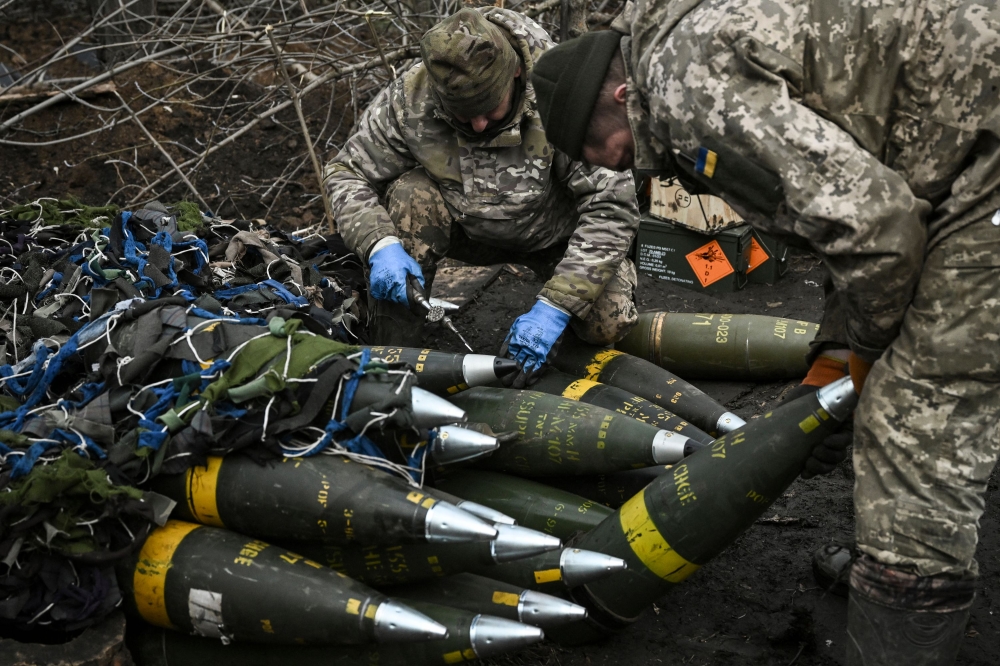 Ukrainian servicemen prepare to fire towards Russian positions with a 155mm M777 Howitzer artillery weapon on the front line somewhere near the city of Bakhmut on March 11, 2023 amid the Russian invasion of Ukraine. — AFP pic