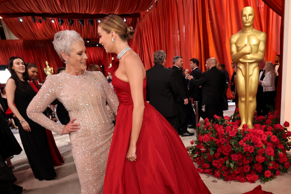 Jamie Lee Curtis and Cara Delavigne pose on the champagne-colored red carpet. — Reuters pic