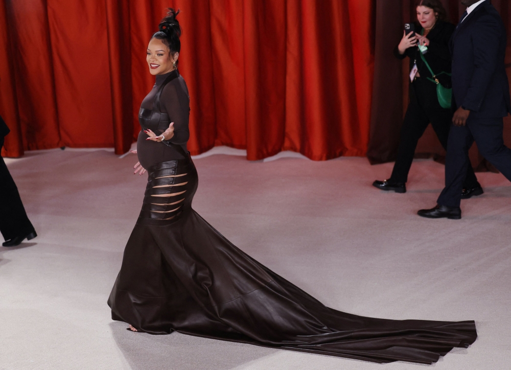 Rihanna, who is pregnant, arrives on the champagne-coloured red carpet. — Reuters pic