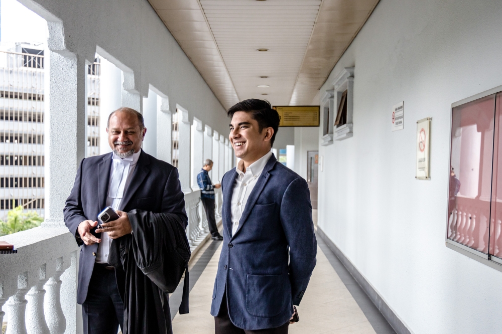 Muar MP Syed Saddiq Syed Abdul Rahman is pictured with his lawyer Gobind Singh Deo at Kuala Lumpur High Court in Kuala Lumpur March 13, 2023. — Picture by Firdaus Latif