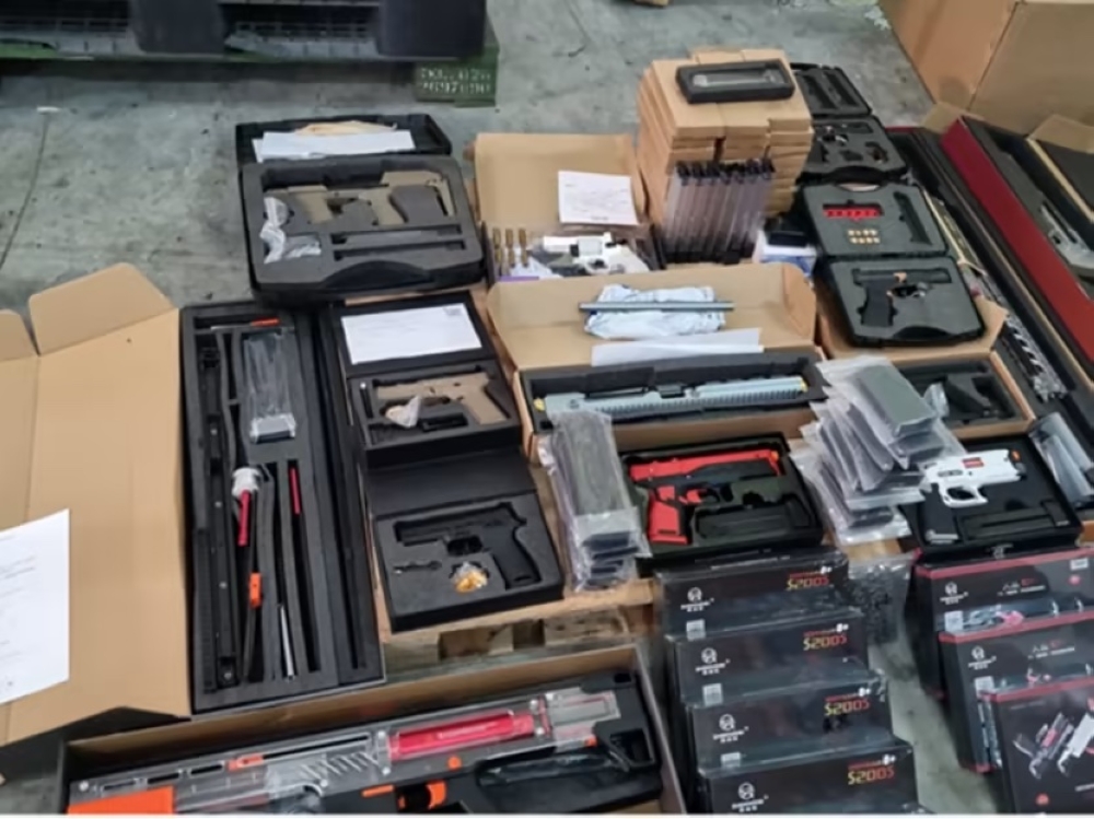 A photograph of a seized shipment of replica guns and magazines. — TODAY pic