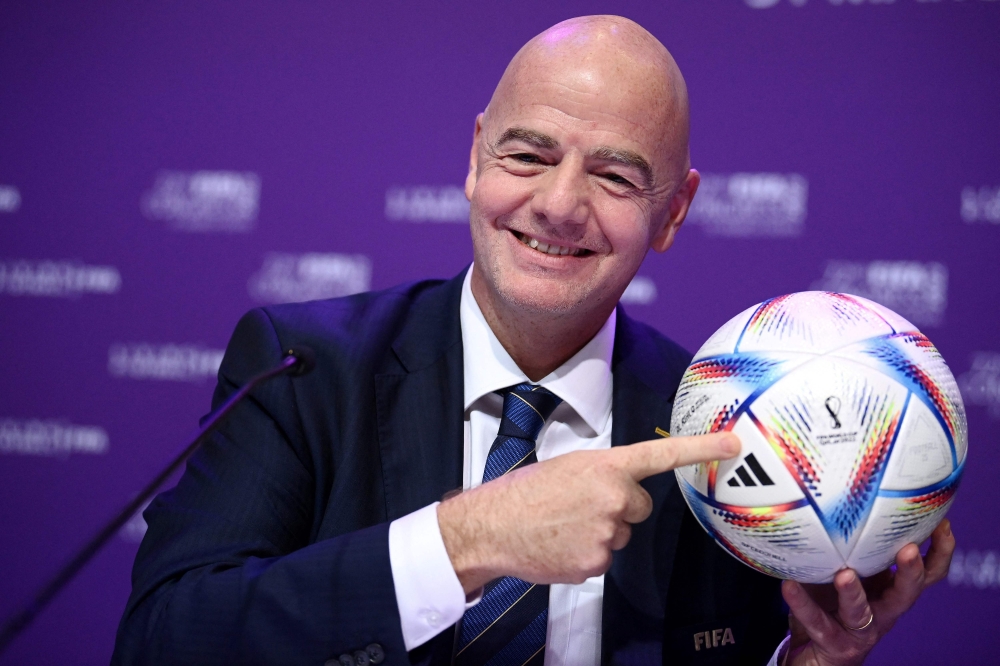 This file photo taken on March 31, 2022 shows Fifa president Gianni Infantino posing with Al Rihla, the official match ball before a press conference during the 72nd Fifa Congress in the Qatari capital Doha. — AFP pic