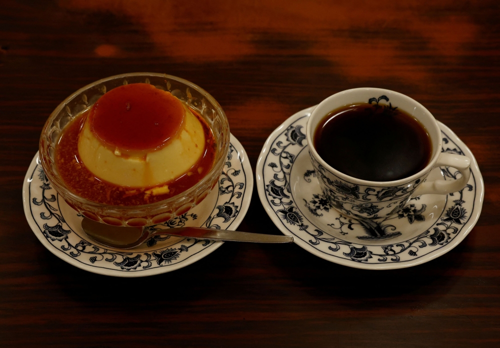 A pudding and a cup of coffee are pictured during a photo opportunity at Shizuo Mori’s Heckeln coffee shop in Tokyo. — Reuters pic