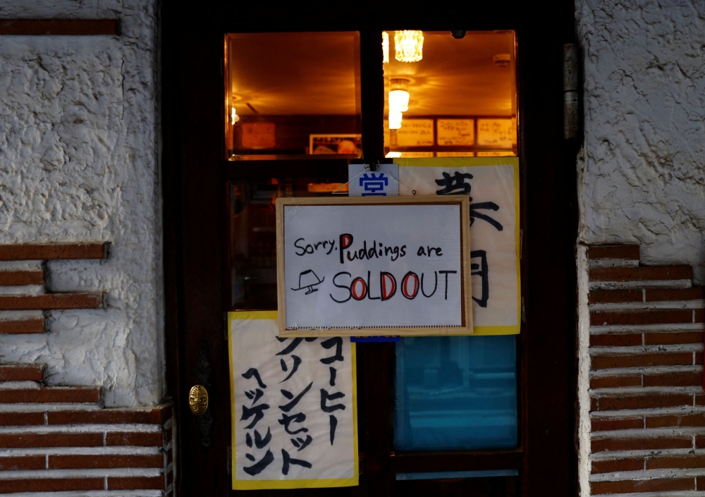 A sign announcing puddings are sold out is hung at Shizuo Mori’s Heckeln coffee shop in Tokyo. — Reuters pic