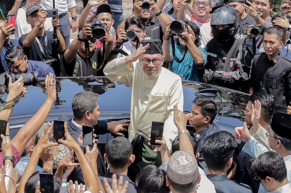 Prime Minister Datuk Seri Anwar Ibrahim waves to the public after performing Friday prayers at Universiti Kebangsaan Malaysia, Bangi March 17, 2023. ― Picture by Sayuti Zainudin
