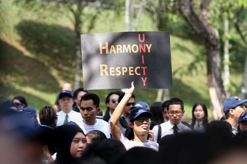 A protester is seen holding a â€˜Unityâ€™ placard during the â€˜Walk for Peace and Freedomâ€™ march, October 16, 2014. â€• Picture by Yusof Mat Isa 