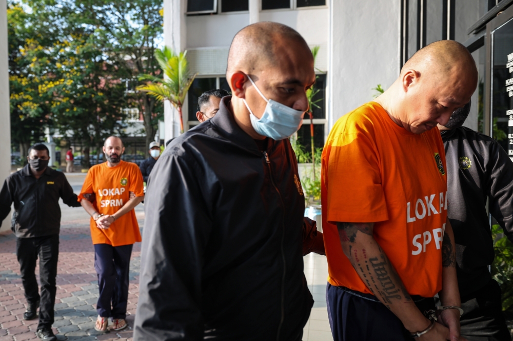 Yesterday, two UK nationals were charged at the Sessions Court in Penang with cheating two Austrians on December 16 last year and January 5 this year out of A$17,564 (RM52,797) to buy shares in a non-existent company called Devon Energy Corporation. — Bernama pic