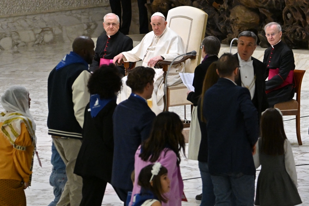 Pope Francis holds an audience to refugees who arrived under humanitarian corridors programme, on March 18, 2023 at Paul-VI hall in The Vatican. — AFP pic
