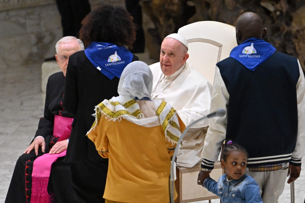 Pope Francis holds an audience to refugees who arrived under humanitarian corridors programme, on March 18, 2023 at Paul-VI hall in The Vatican. — AFP pic