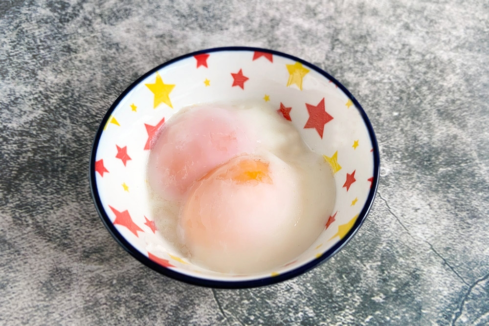 The final flourish of 'onsen' eggs elevates the congee.
