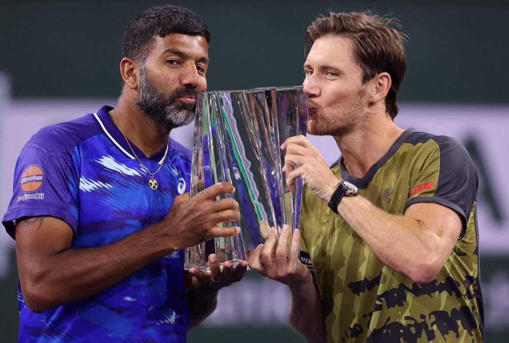 Rohan Bopanna of India and Matthew Ebden of Australia celebrate with the winners trophy after defeating Wesley Koolhof of Netherlands and Neal Skupski of Great Britain in the doubles final during the BNP Paribas Open on March 18, 2023 in Indian Wells, California. — Julian Finney/Getty Images/AFP pic