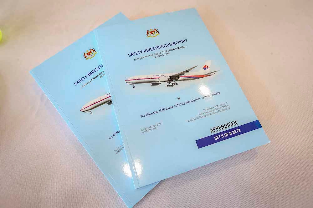 Copies of the MH370 briefing report are seen at a press conference in Putrajaya July 30, 2018. — Picture by Firdaus Latif