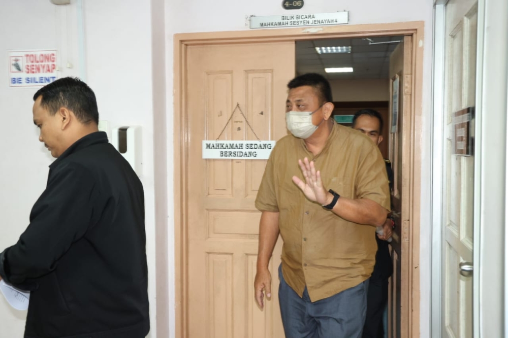 Petrol station owner Phan Chib Chan (right) leaving the court room after he pleaded guilty and was fined at the Johor Baru Session’s Court March 21 2023 — Picture by Ben Tan
