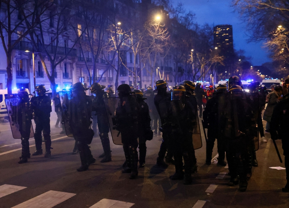 French CRS riot police officers stand guard during a demonstration in Paris March 20, 2023. — Reuters pic