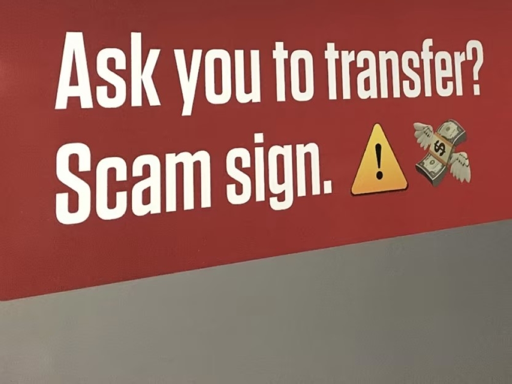 A sign at an MRT station in Singapore warning people to beware of scams. — TODAY pic