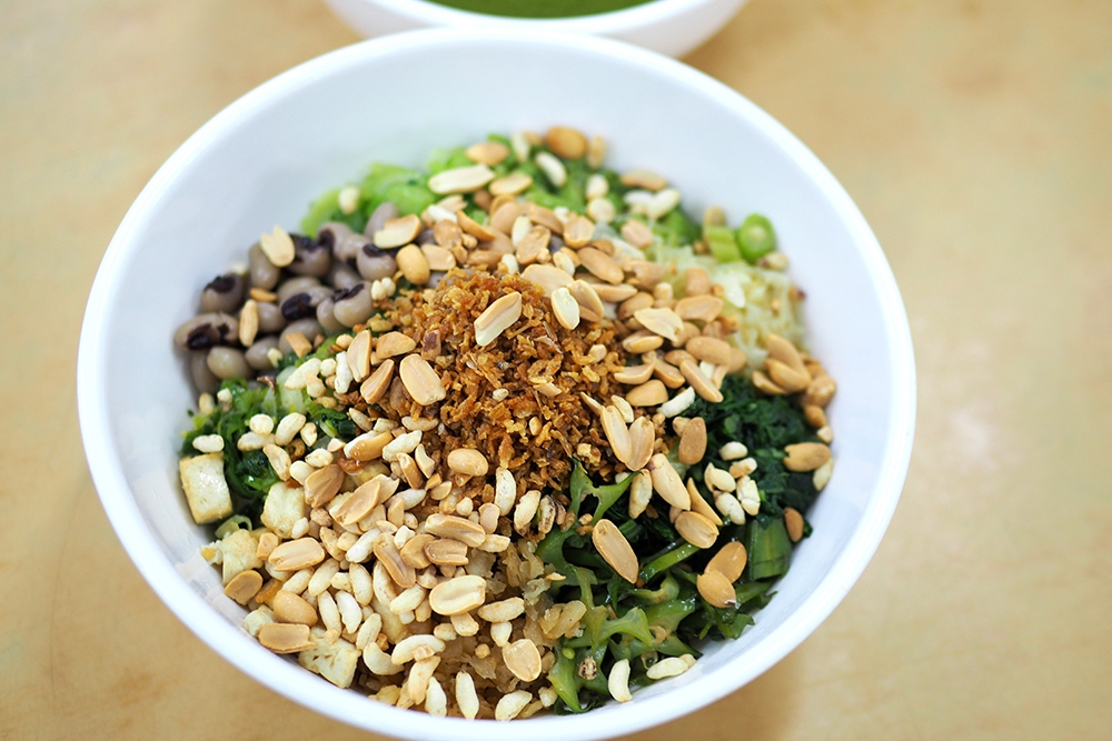 You open packets of rice puffs and roasted peanuts to sprinkle on the Lei Cha for the crunchy element.