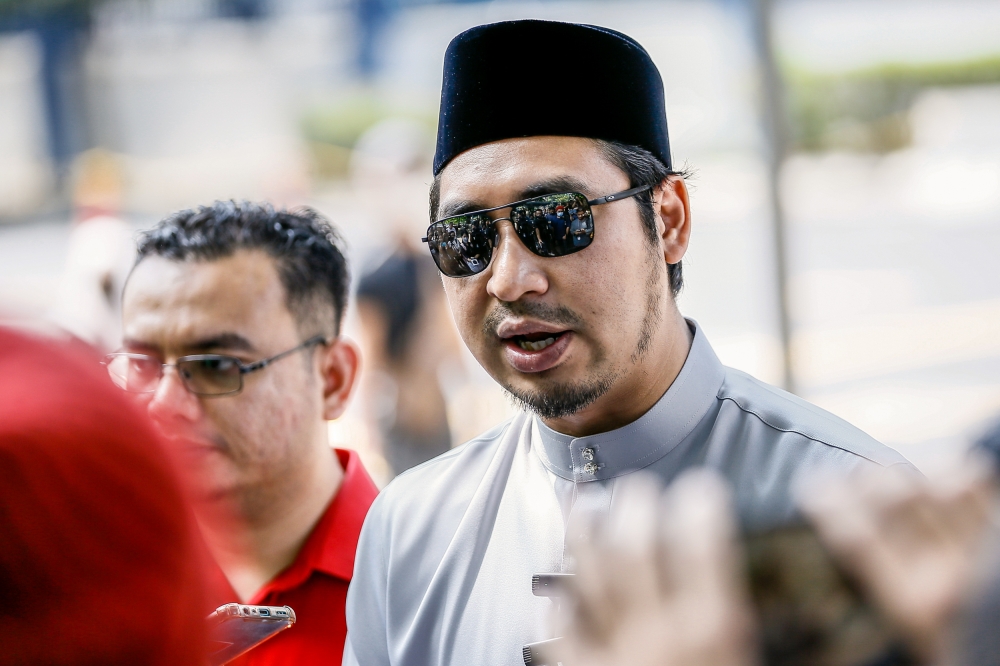 Bersatu Youth chief Wan Fayhsal Wan Ahmad Kamal speaks to reporters after making a police report at the IPD Dang Wangi in Kuala Lumpur March 24, 2023. — Picture by Hari Anggara
