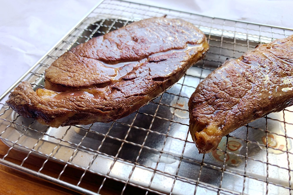 The glistening comes from rendered fat after searing.