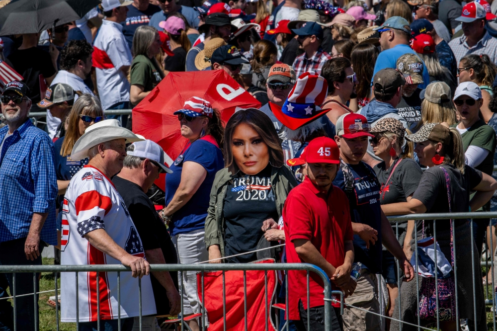 A person wearing a cut-out prop of former first lady Melania Trump while waiting in line at the Waco Regional Airport ahead of former US President Donald Trump’s arrival on March 25, 2023 in Waco, Texas. — AFP pic
