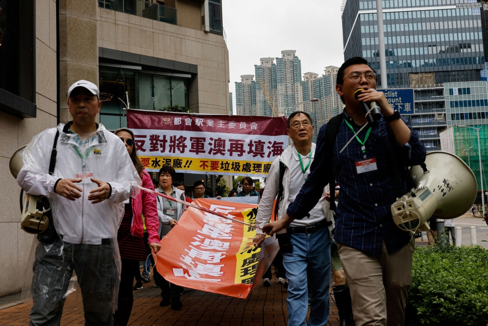 Protesters are required to wear numbered lanyards around their necks as they protest against a land reclamation and waste transfer station project during one of the first demonstrations to be formally approved since the enactment of a sweeping national security law, in Hong Kong, China March 26, 2023. — Reuters pic