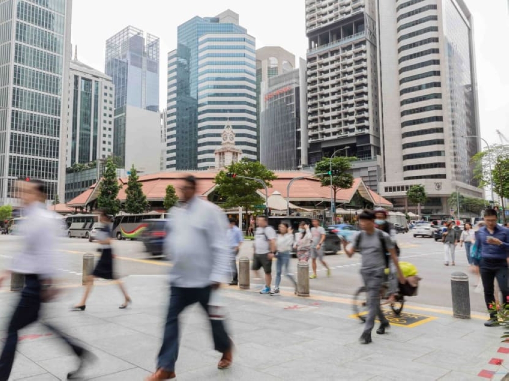 People walking in the central business district in Singapore on March 15, 2023. — TODAY pic