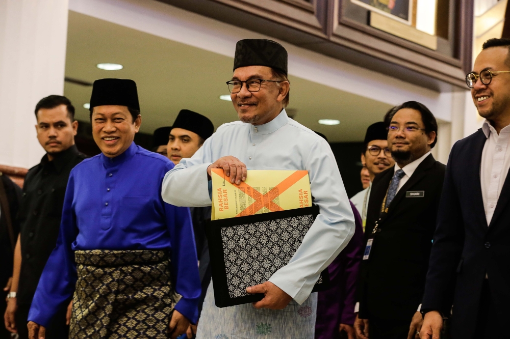 A file photograph shows Prime Minister Datuk Seri Anwar Ibrahim (centre) arriving to table Budget 2023 in Parliament on February 24, 2023. — Picture by Sayuti Zainudin.