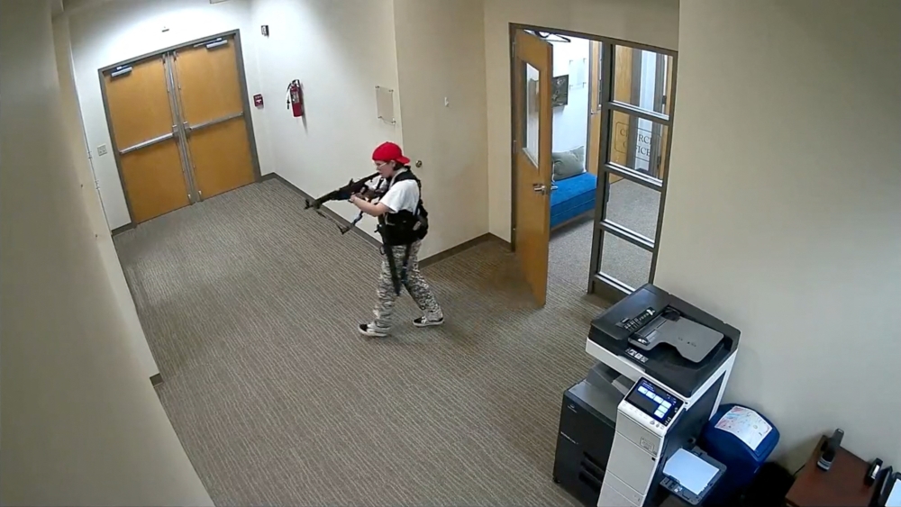A still image from surveillance video shows what the Metropolitan Nashville Police Department describe as mass shooting suspect Audrey Elizabeth Hale, walking in The Covenant School, Nashville, carrying weapons. — Reuters pic