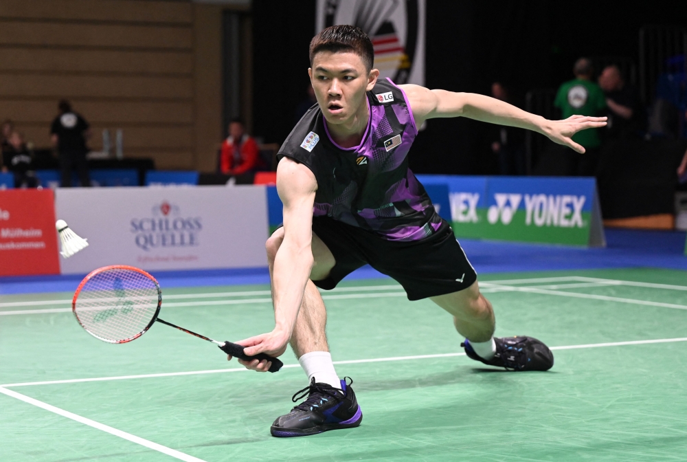 Lee Zii Jia of Malaysia plays against Magnus Johannesen of Denmark during the men's singles first round match of the Badminton German Open in Muelheim March 8, 2023.— AFP pic