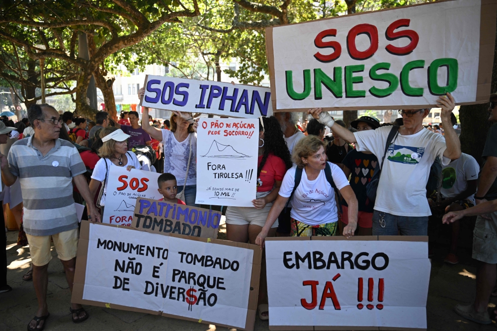 Protestors demonstrate against proposals to create a zip line attraction at Sugarloaf Mountain in Rio de Janeiro, Brazil, on March 26, 2023. — AFP pic