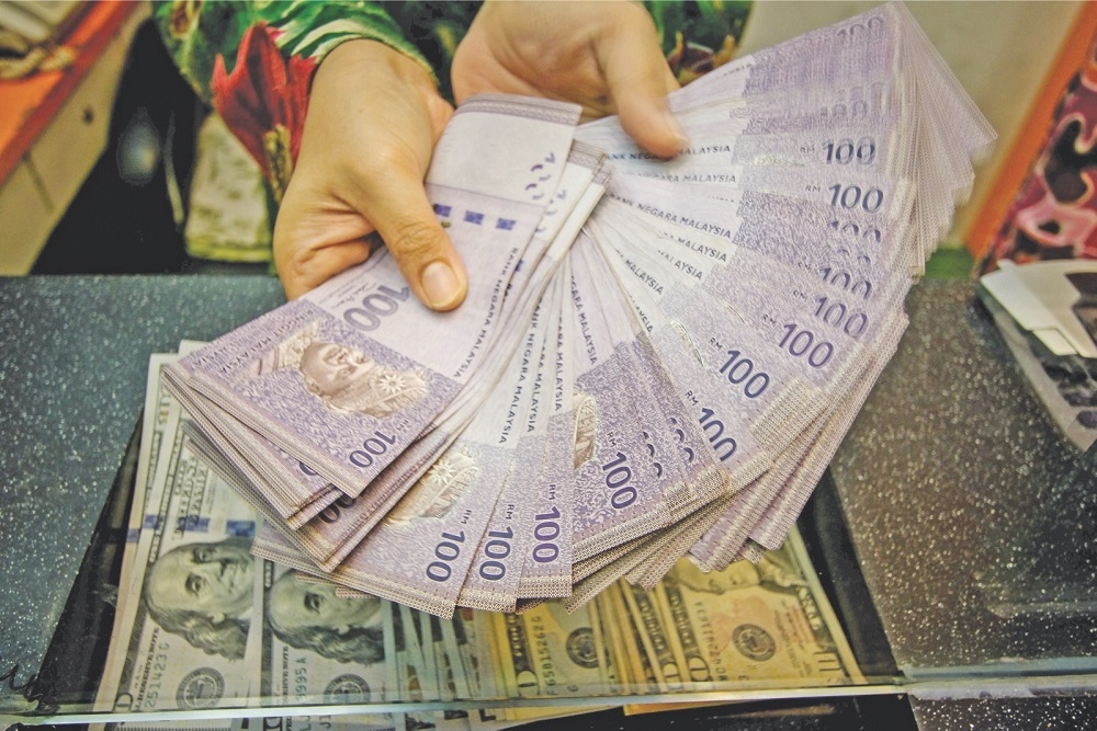 The ringgit opened lower against the greenback as the US Dollar Index (DXY) was slightly higher by 0.20 per cent to 102.64 overnight. ― Picture by Hari Anggara