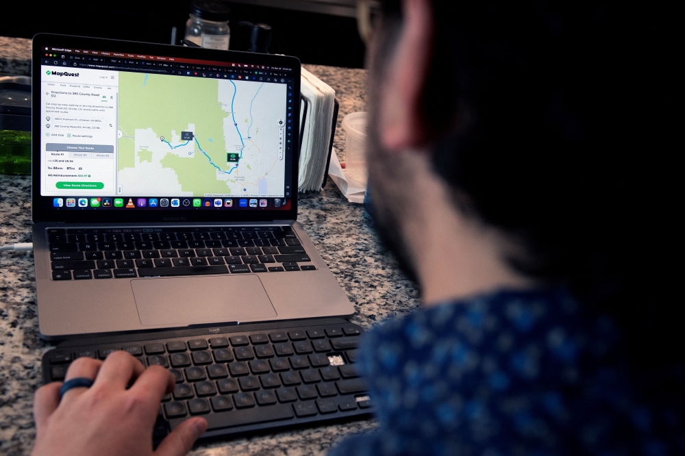 Jose Briones uses Mapquest on his computer to get directions, which he will print out, for an upcoming trip at his apartment in Littleton, Colorado on March 24, 2023. — AFP pic