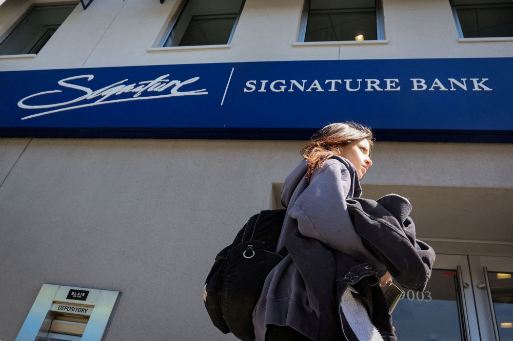 A woman walks past a Signature Bank location in Brooklyn, New York March 20, 2023. ― Reuters file pic