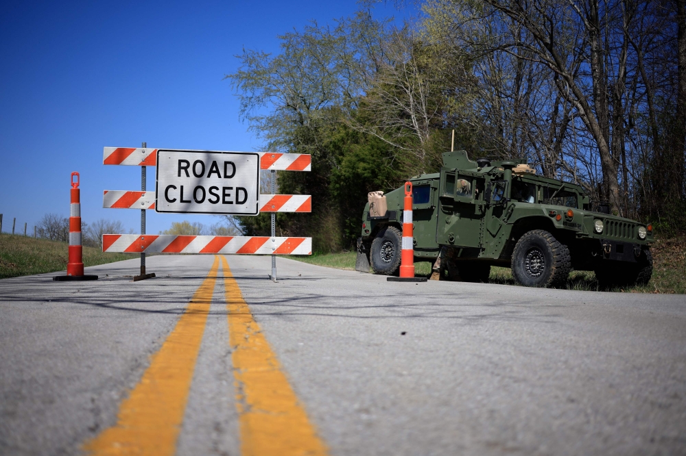 A Humvee from the US Army's 101st Airborne Division sits parked at a checkpoint near the site where two UH-60 Blackhawk helicopters crashed on March 30, 2023 in Cadiz, Kentucky. — Luke Sharrett/Getty Images/AFP pic